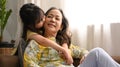 Cute little girl hugging and kissing her grandmother spending leisure weekend time together at home, happy moment, love Royalty Free Stock Photo