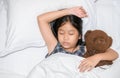 Cute little girl hugging teddy bear sleeping lay in  bed Royalty Free Stock Photo