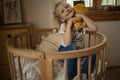 Cute little girl hugging teddy bear smiling while sitting on her bed at home Royalty Free Stock Photo