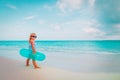 Cute little girl with inflatable life ring go swim at beach