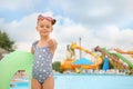 Cute little girl with inflatable ring near pool in water park Royalty Free Stock Photo