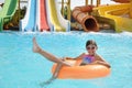 Cute little girl with inflatable ring in pool at water park Royalty Free Stock Photo