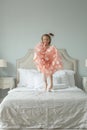 Cute little girl jumping on the bed, childhood concept Royalty Free Stock Photo