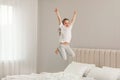 Cute little girl jumping on bed at home Royalty Free Stock Photo