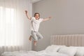 Cute little girl jumping on bed at home Royalty Free Stock Photo