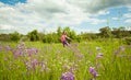 Cute little girl jumping on a green summer meadow Royalty Free Stock Photo