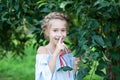 Cute little girl keeping a secret or asking for silence. kid girl shows shh sign. Portrait of girl with pigtail on her head stands Royalty Free Stock Photo