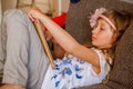 Cute girl kid using iPad digital computer tablet on bed for education or playing game. Royalty Free Stock Photo