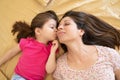 Cute little girl kissing her mom Royalty Free Stock Photo