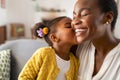 Cute little girl kissing mother on cheek