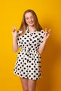 Cute little girl laughs and smiles on a yellow background. Happy teenage girl with braces on her teeth Royalty Free Stock Photo