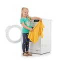 Cute little girl with laundry near washing machine Royalty Free Stock Photo
