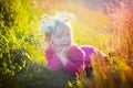 Cute little girl laying in a field Royalty Free Stock Photo