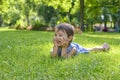 Cute little girl laying in the grass on a summer day Royalty Free Stock Photo