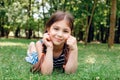 Cute little girl laying on green fresh grass outdoor Royalty Free Stock Photo