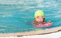 Cute little girl learning how to swim. Royalty Free Stock Photo