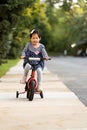 Cute little girl learning ride a bicycle with no helmet Royalty Free Stock Photo