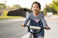 Cute little girl learning ride a bicycle with no helmet