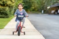 Cute little girl learning ride a bicycle with no helmet