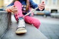 Cute little girl learning to tie shoelaces outdoors Royalty Free Stock Photo