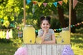 Cute little girl at lemonade stand. Summer refreshing natural drink Royalty Free Stock Photo