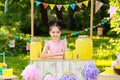 Cute little girl at lemonade stand in park. Summer refreshing Royalty Free Stock Photo