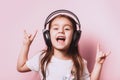 Cute little girl listening music wearing headphones. Royalty Free Stock Photo