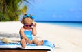 Cute little girl listening to shell on beach Royalty Free Stock Photo