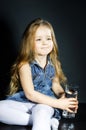 Cute little girl with long hair holding glass of water Royalty Free Stock Photo