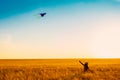 Cute little girl with long hair running with kite in the field on summer sunny day