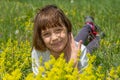 Cute little girl lying in the grass and flowers and laughing Royalty Free Stock Photo