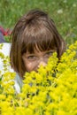 Cute little girl lying in the grass and flowers and laughing Royalty Free Stock Photo