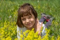 Cute little girl lying in the grass and flowers and laughing Royalty Free Stock Photo