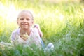 Cute little girl lying on green grass outdoors Royalty Free Stock Photo
