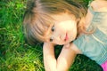 Cute little girl lying on green grass Royalty Free Stock Photo