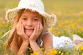 Cute little girl lying on the meadow on sunny day