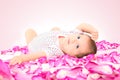 Cute little girl, lying in rose petals Royalty Free Stock Photo