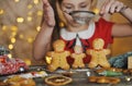 Cute little girl makes traditional gingerbread men.