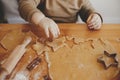 Cute little girl making christmas cookies on messy table, close up. Adorable toddler daughter helping mother and cutting dough for Royalty Free Stock Photo