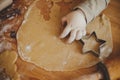 Cute little girl making christmas cookies on messy table, close up. Adorable toddler daughter helping mother and cutting dough for Royalty Free Stock Photo