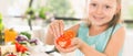 Cute little girl making salad. Child cooking. Healthy food Royalty Free Stock Photo