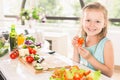 Cute little girl making salad. Child cooking. Healthy food Royalty Free Stock Photo