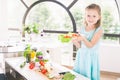 Cute little girl making salad. Child cooking. Healthy food Royalty Free Stock Photo