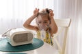 Cute little girl in the mask of an inhaler. Having fun. Procedure of inhalation at home. Kid taking respiratory therapy with Royalty Free Stock Photo