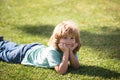 Cute little girl on the meadow in spring day. Happy childhood. Boy lying on grass. Cute kid child enjoying summer on Royalty Free Stock Photo
