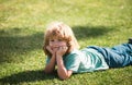 Cute little girl on the meadow in spring day. Happy childhood. Boy lying on grass. Cute kid child enjoying summer on Royalty Free Stock Photo