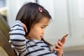 Cute little girl mesmerised by a mobile phone Royalty Free Stock Photo