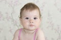 Cute little girl 10 months old, baby portrait close-up. The baby is looking at the camera with a serious face, baby girl with Royalty Free Stock Photo