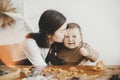 Cute little girl and mother making together christmas gingerbread cookies. Happy mom kissing adorable toddler daughter. Lovely Royalty Free Stock Photo