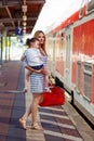 Cute little girl and mother on a railway station. Royalty Free Stock Photo